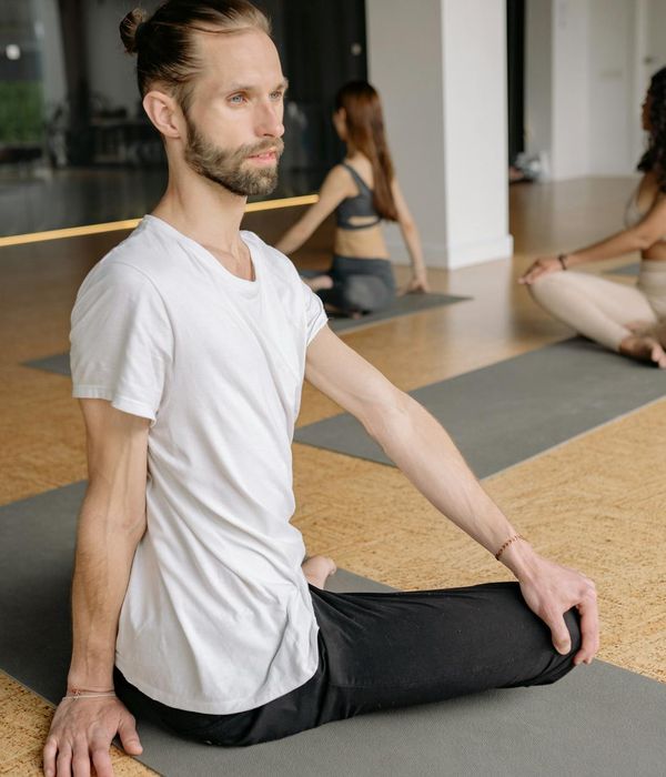 Group of diverse people sitting in a calm yoga class.